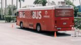 red and white coca cola bus on road during daytime